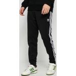Przecenione Czarne Spodnie dresowe bawełniane męskie w paski marki adidas w rozmiarze S 