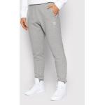 Przecenione Szare Spodnie dresowe męskie rurki marki Adidas Originals w rozmiarze M 