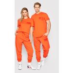 Przecenione Pomarańczowe Spodnie dresowe damskie luźne marki Diadora w rozmiarze XS 